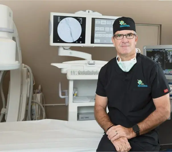 dr-magnant-in-office Renowned vein specialist and vascular surgeon Dr. Joseph Magnant