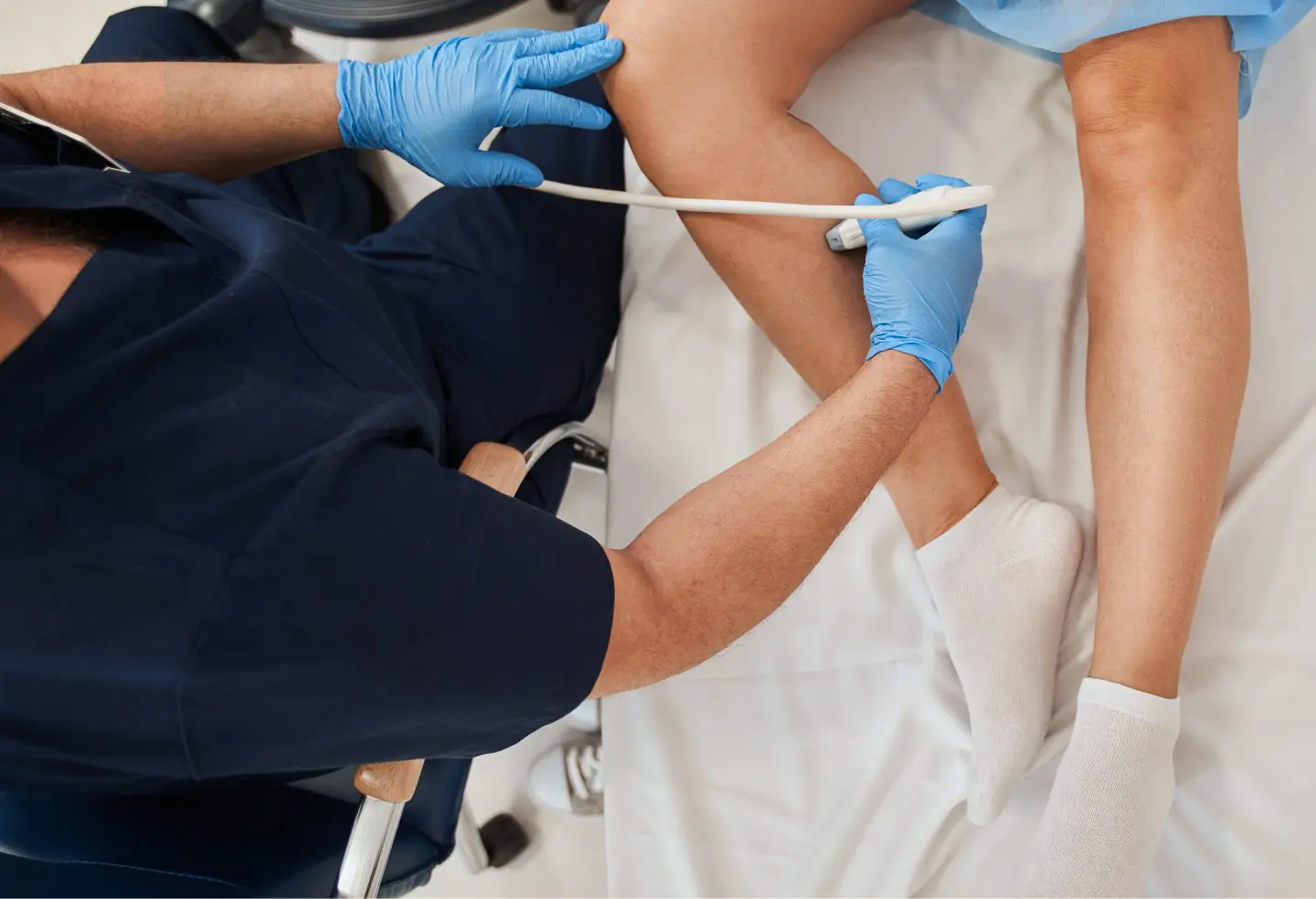 Medical professional looking at veins to determine treatment